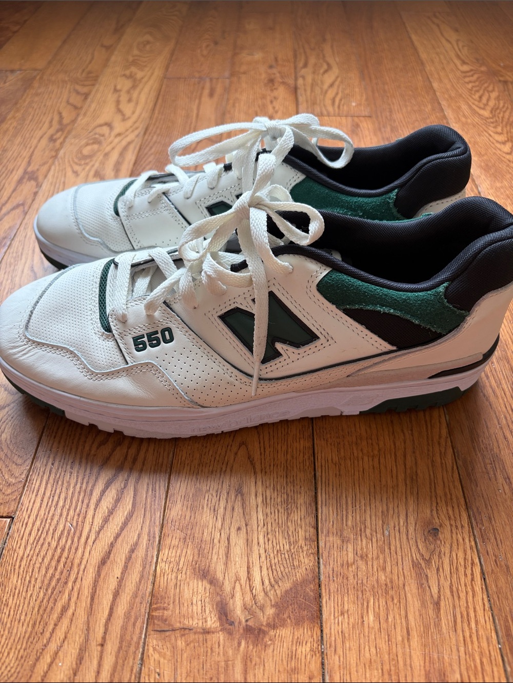 New Balance 550 Sea Salt Pine Green sneakers featuring a classic retro design
